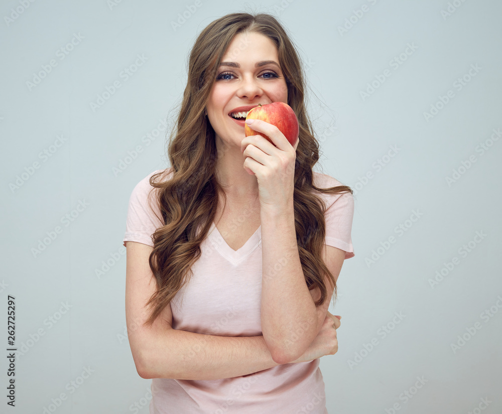 smiling woman in pink shirt holding red apple. smiling woman in pink shirt holding red apple.