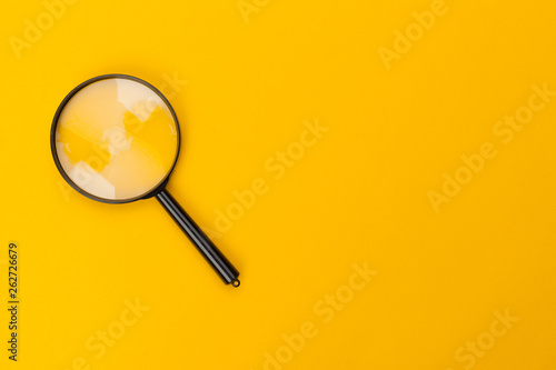 magnifying glass on yellow background