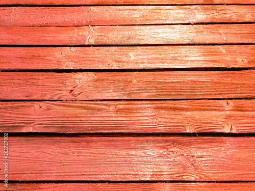 Bright red fence. Orange color fence boards.