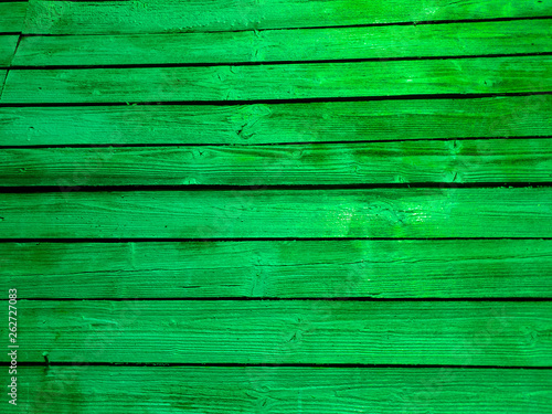 Bright green fence. Green fence boards the close-up