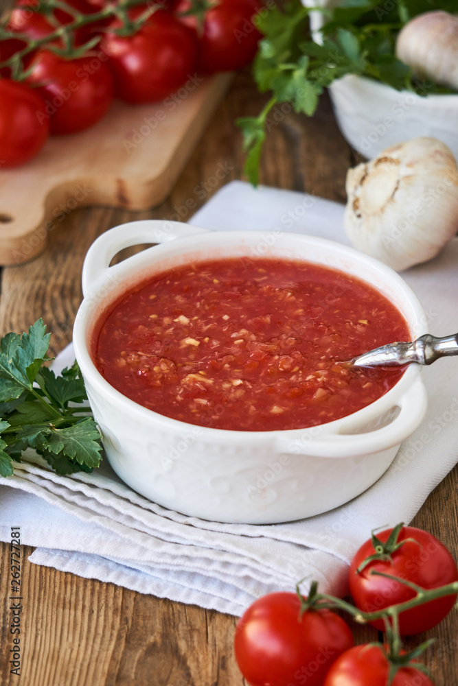Spicy tomato sauce with garlic and horseradish in a white bowl Spicy tomato sauce with garlic and horseradish in a white bowl