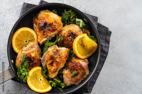 Chicken thighs with orange is a pan.
