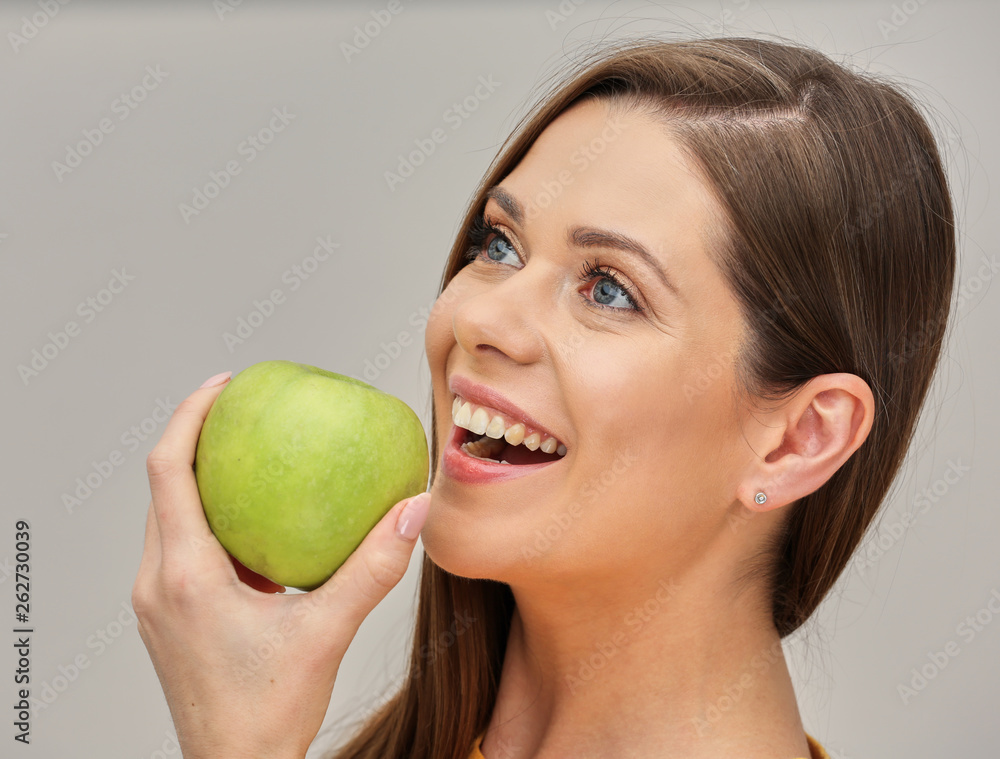 close up portrait of smiling woman with healthy teeth holding green apple. close up portrait of smiling woman with healthy teeth holding green apple.