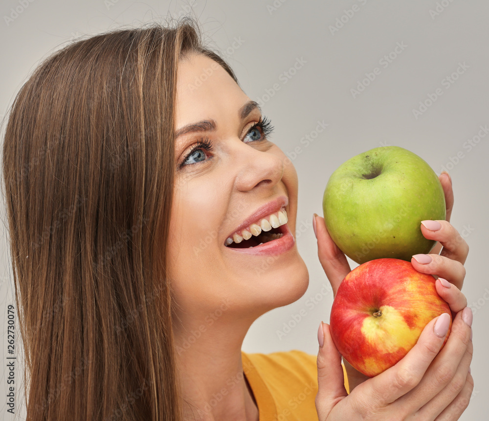 woman smiling with healthy teeth holding two apples. woman smiling with healthy teeth holding two apples.