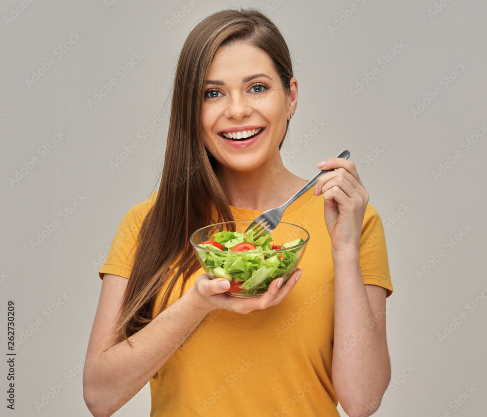 young woman eating healthy green food, salad with tomatoes. young woman eating healthy green food, salad with tomatoes.