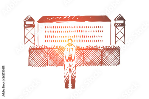 Prisoner in handcuffs standing outside jailhouse, jail break attempt, building with metal fence, watchtowers