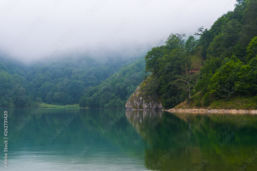 mountain lake in the misty morning