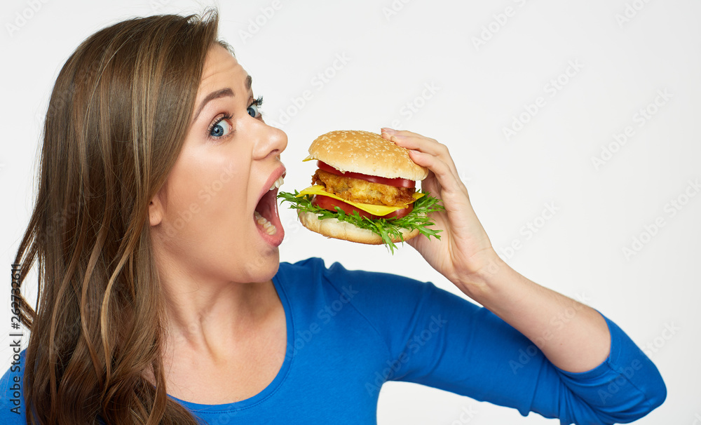 woman eating big burger. Isolated portrait. woman eating big burger. Isolated portrait.