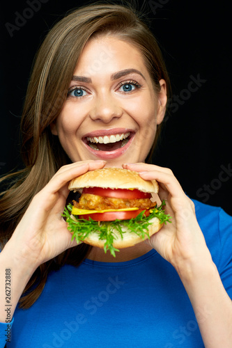 happy woman holding burger on black background.