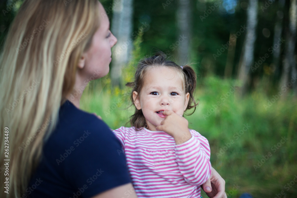 Beautiful woman and her little daughter having fun in the meadow, single mother concept, copy space Beautiful woman and her little daughter having fun in the meadow, single mother concept, copy space
