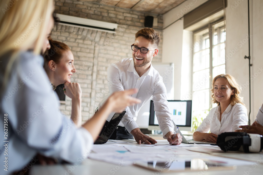 Happy creative team in office. Business, startup, design, people and teamwork concept Happy creative team in office. Business, startup, design, people and teamwork concept