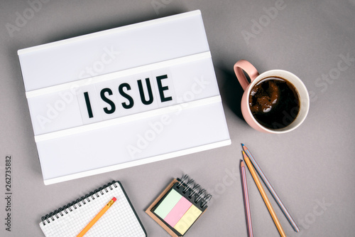 Issue. Text in light box. Pink coffee mug on gray background