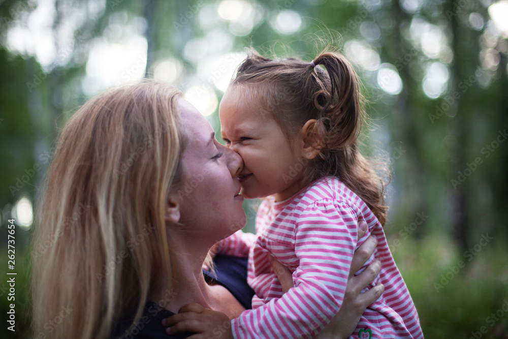 Beautiful woman and her little daughter having fun in the meadow, single mother concept, copy space Beautiful woman and her little daughter having fun in the meadow, single mother concept, copy space