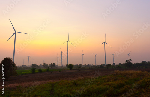 A Wind Turbine on a Wind Farm at sunrise time.