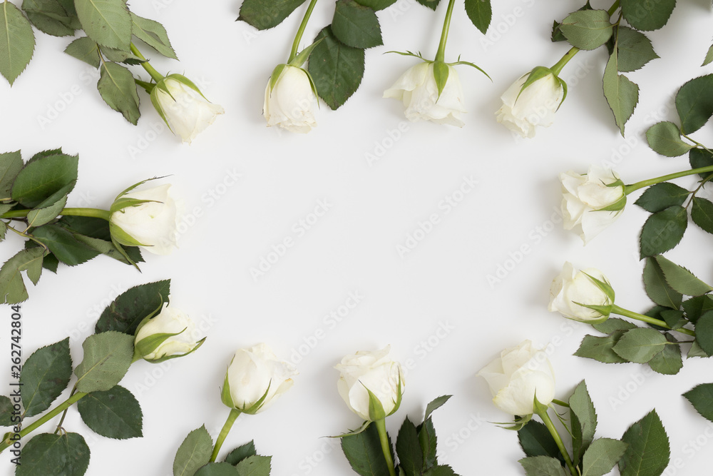 Roses on a white table. Flat lay with blank copy space.