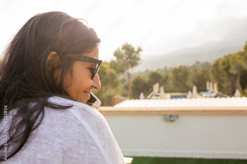 young Indian woman talking  on mobile phone