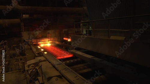 Steel mill, steel sheet production, transportation of hot sheets on the production line, heavy industry, metal rolling plant. Conveyor line metal rolling mill. Machine continuous casting blanks.