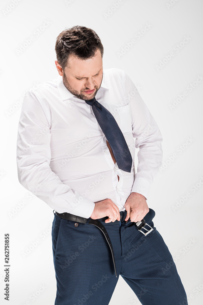 overweight man in formal wear putting on tight pants on white Stock-Foto |  Adobe Stock