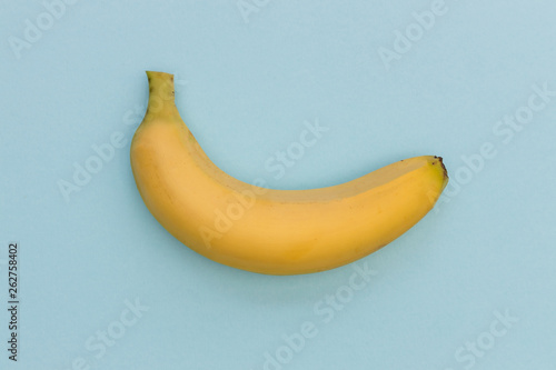 Yellow banana isolated on blue color background minimal fruit food top view