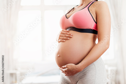 Free Download Beautiful pregnant woman holding her baby belly – close up   - GFXLoad