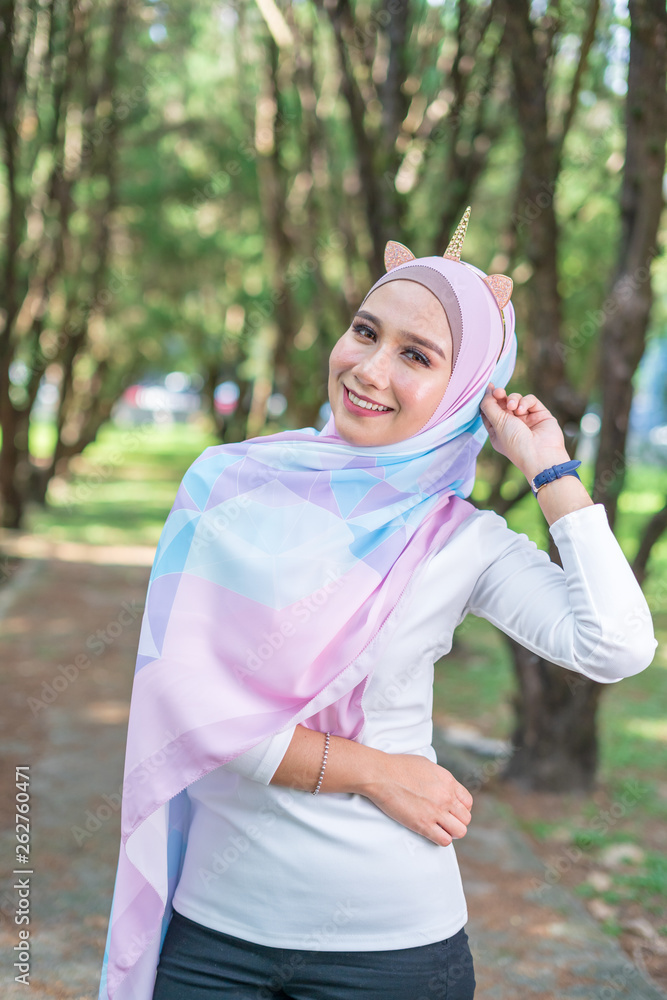 Portrait of lovely young Malay woman, modern stylish Muslim fashion, nature background. Selective focus. Portrait of lovely young Malay woman, modern stylish Muslim fashion, nature background. Selective focus.