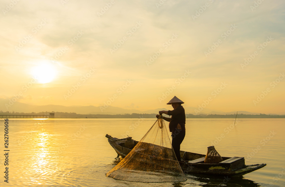 Silhouette Fisherman Fishing Nets on the boat.Thailand Silhouette Fisherman Fishing Nets on the boat.Thailand