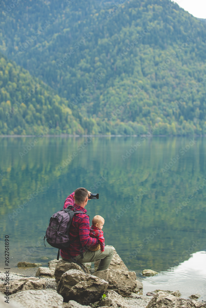 Dad and son walk by the lake