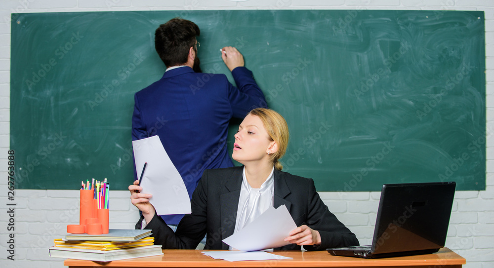 teacher and student on exam. businessman and secretary. back to school. formal education. paper work. office life. business couple use laptop and documents. Feeling confident in her future teacher and student on exam. businessman and secretary. back to school. formal education. paper work. office life. business couple use laptop and documents. Feeling confident in her future
