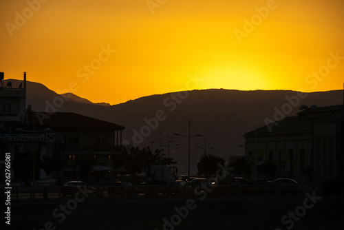 Greece, Crete, August 2018: Sunset in the city of Heraklion behind the mountains
