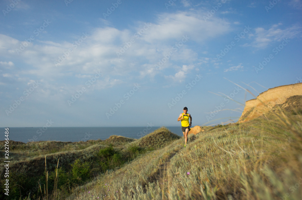 Sport running man in cross country trail run Sport running man in cross country trail run