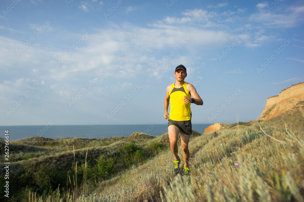 Sport running man in cross country trail run Sport running man in cross country trail run