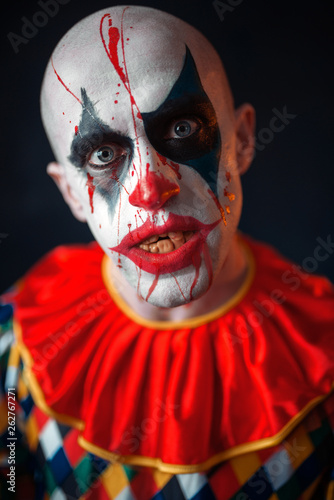 Portrait of mad bloody clown, face in blood