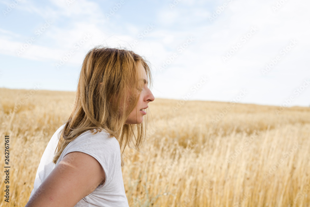 Portrait of beautiful young woman in stylish clothes posing on field Portrait of beautiful young woman in stylish clothes posing on field