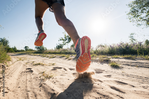 Sport running man in cross country trail run