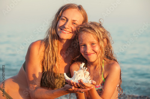 Girl with mother on sea background © Tatyana Gladskih