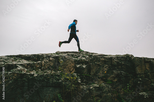 Sport running man in cross country trail run