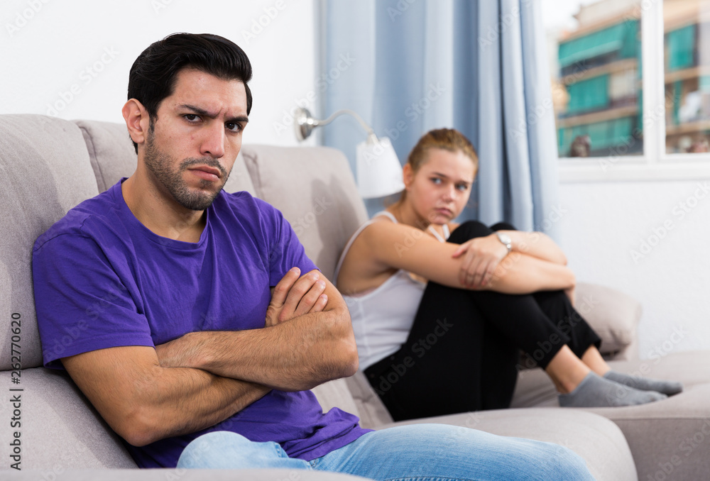 Fototapeta premium Guy on couch after discord with girlfriend