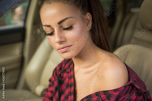 Young woman in red shirt in the car