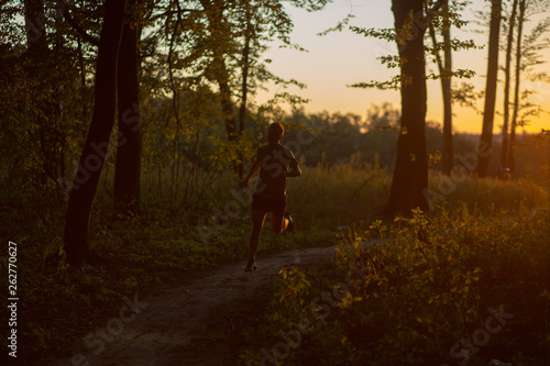 Sport running man in cross country trail run on sunset © Alena Kovalenko