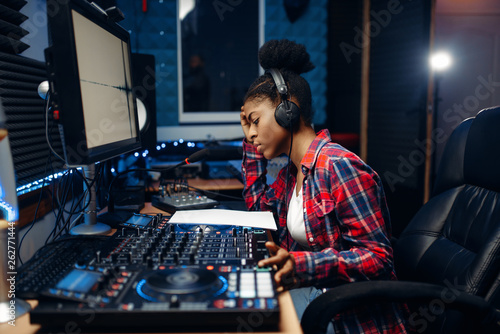 Fototapeta Female sound operator in audio recording studio