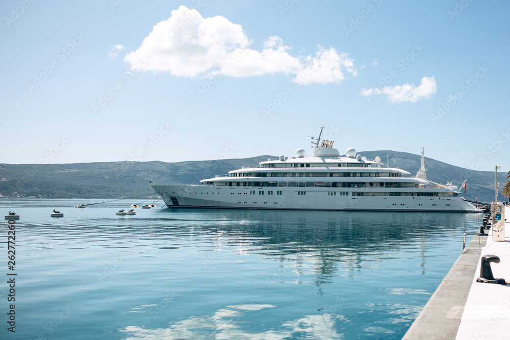 The ship or yacht is moored at the shore and awaits navigation. Summer sea vacation or cruise.
