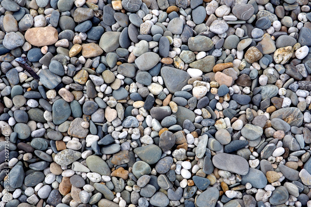 Textured pebbles on a rocky beach, from above Textured pebbles on a rocky beach, from above