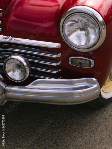 part of a red classic vintage car © Kuzmaphoto