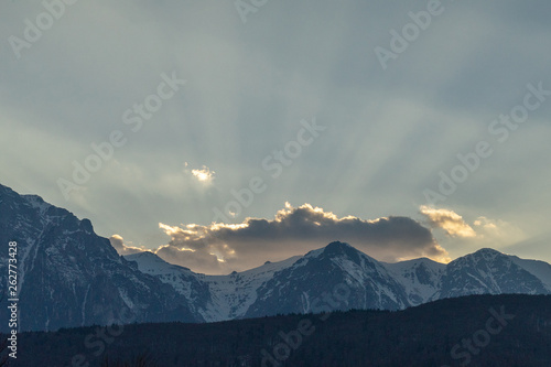 Dramatic clouds over mountains, at sunset time