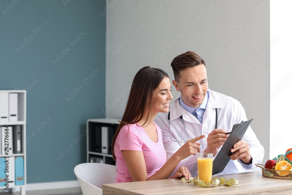 Young woman visiting nutritionist in weight loss clinic Young woman visiting nutritionist in weight loss clinic