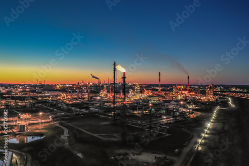 Russia. Ufa. April 2019. Башнефть Bashneft Flying above chemical factory (refinery) in the late evening. Lights of night Ufa.