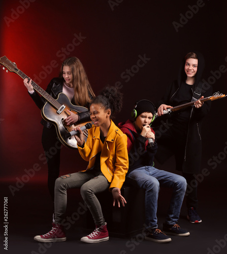 Band of teenage musicians on dark background © Pixel-Shot