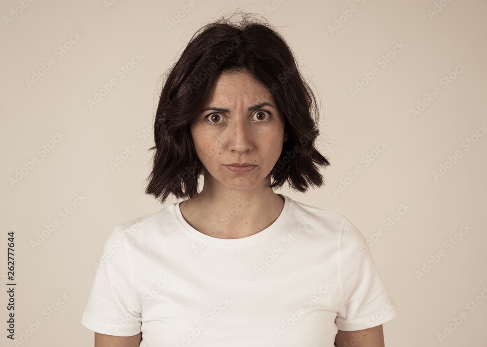 Portrait of a beautiful young woman with angry face looking furious. Human expressions and emotions Portrait of a beautiful young woman with angry face looking furious. Human expressions and emotions