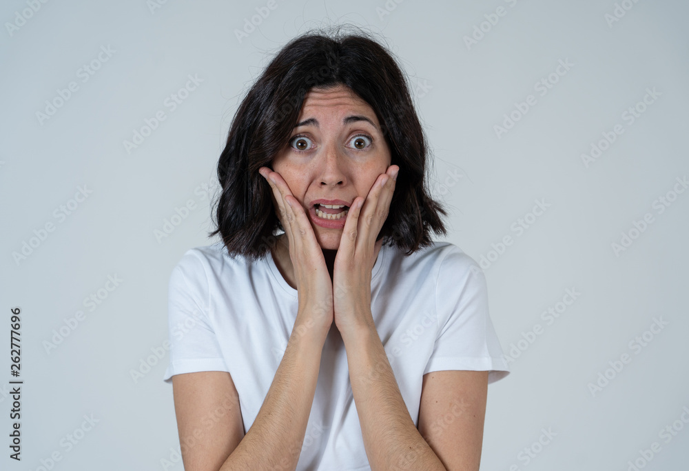 Portrait of a young attractive woman looking scared and shocked.Human expressions and emotions Portrait of a young attractive woman looking scared and shocked.Human expressions and emotions