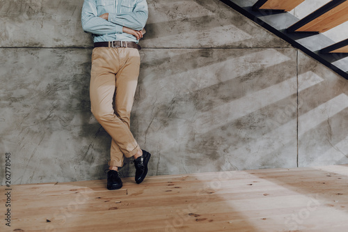 Trendy man spending time near steps inside photo